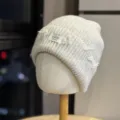 Close-up of the textured knit detail and frayed patch on the warm slouchy beanie hat. - Adult One Size (54-60cm) / Beige