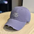 Detail shot of a purple distressed baseball cap with front embroidery slogan, casual street style. - Adult 54-60 Adjustable / Purple
