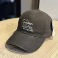 Casual dark grey baseball cap with white embroidered text, soft top and wide brim for daily wear. - Adult 54-60 Adjustable / Coffee