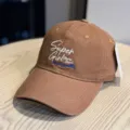 Detail view of brown embroidered baseball cap showing front letter stitching and soft crown design. - Adult 54-60 Adjustable / Caramel color