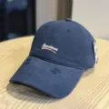 Classic washed cotton baseball cap with embroidered lettering and distressed brim style. - Adult 54-60 Adjustable / Navy Blue