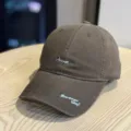 Detailed view of brown baseball cap with trendy embroidered text, curved brim streetwear. - Adult 54-60 Adjustable / Coffee