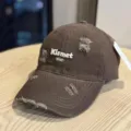 Close-up detail of the brown distressed washed baseball hat with Kismet star embroidery. - Adult 54-60 Adjustable / Coffee