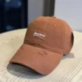 Brown washed cotton baseball cap with embroidered lettering and distressed brim for a stylish look. - Adult 54-60 Adjustable / Orange