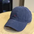 Close-up detail of dark blue washed cotton dad hat with red embroidered text design - Adult 54-60 Adjustable / Navy Blue