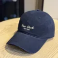 Navy blue baseball cap featuring stylish white embroidered New York text and vintage EST 1987 detail. - Adult 54-60 Adjustable / Navy Blue