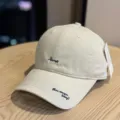 Detail shot of a beige baseball cap with embroidered lettering, showcasing fine fabric texture. - Adult 54-60 Adjustable / Beige