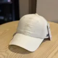Detailed view of the white quick-drying baseball cap with embroidery letter design, breathable fabric. - Adult 54-60 Adjustable / Beige