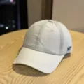 Detail of the lightweight quick-dry baseball cap with blue embroidery and breathable eyelets. - Adult 54-60 Adjustable / Light Gray