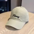 Closeup view of lightweight quick-dry beige baseball cap featuring stylish black Fairway text. - Adult 54-60 Adjustable / Khaki