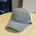 Close-up detail of grey quick-dry baseball cap with stylish embroidered letter side accent. - Adult 54-60 Adjustable / Dark Gray