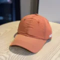 Orange grid quick-drying baseball cap for men and women, breathable summer sun hat for casual wear. - Adult 54-60 Adjustable / Orange