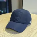 Detail view of the navy blue quick-drying baseball cap with MY embroidery logo side. - Adult 54-60 Adjustable / Navy Blue
