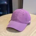 Close-up detail of the purple breathable grid baseball cap, showcasing fine fabric and embroidery. - Adult 54-60 Adjustable / Deep purple