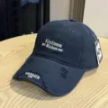 Navy blue baseball cap with distressed brim and stylish white embroidery for casual daily wear. - Adult 54-60 Adjustable / Navy Blue