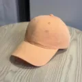 Detail view of the stylish peach pink baseball cap with subtle side embroidery for casual streetwear. - Adult 54-60 Adjustable / Orange