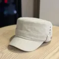 Details of the beige flat top cap featuring side rivets and textured fabric, close-up view. - Adult 54-60 Adjustable / Beige