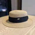 Close-up of the elegant straw boater hat featuring black ribbon and metallic detail accent. - Adult Adjustable 54-60 / Khaki with Black Ribbon