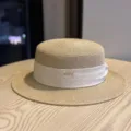 Elegant straw flat top hat with white ribbon and metal detail, perfect for summer sun protection. - Adult Adjustable 54-60 / Khaki with Beige Ribbon