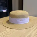 Detailed view of the stylish women's flat-top straw hat with purple ribbon and metal accent. - Adult Adjustable 54-60 / Khaki Purple Ribbon