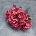 Detail shot of artificial red hydrangea flower bunch for wedding decor and floral designs. - Red