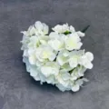 Detailed close-up of white artificial hydrangea flower head, realistic 3D craft for decor. - White