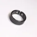 Detail view of the black metallic open adjustable health magnetic ring showing inner dual magnets. - 2 Magnets Black