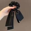 Elegant black satin hair scrunchie with long ribbon bow and pearl edge for women stylish look - Black