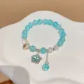 Bracelet perles craquées cristal bleu avec pendentif étoile scintillant variante bijoux femme. - Bleu ciel
