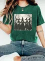 Close-up detail view of the dark green graphic t-shirt featuring a vintage witch illustration. - Wheat Green
