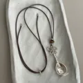 Brown cord necklace featuring a metallic spoon pendant, flower charm, and tiger's eye beads. - Style 4 (Flower Spoon Pendant)