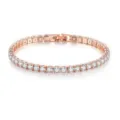 Gros plan détaillé du bracelet tennis étincelant en or rose avec des pierres de cristal rondes. - 4mm / Or rose