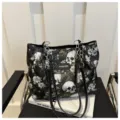 Black canvas tote bag with skull and floral print, stylish large capacity shoulder handbag. - Black