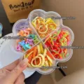 Detailopname van een bloemvormige opbergdoos met kleurrijke haarelastiekjes en mini-klemmen. - Geribbelde Banden en Klemmen Set / Bloem Opbergdoos / Geel (Veelkleurig)