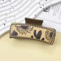 Vista detallada de la pinza de pelo de cuero estilo western con estampado de girasol y cactus. - Girasol