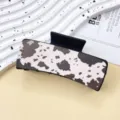 Stylish cow print hair claw clip for women, western cowboy style shark clip for daily hair styling. - Black Cow Pattern