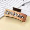Western style leather hair claw clip with cow print and honey letter design for women. - HOWDY Letters