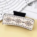 Geometric pattern leather hair claw clip detail close-up, stylish western style hair accessory. - Diamond Pattern