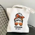 White canvas tote bag with teacher graphic design, reusable shoulder shopping bag. - Style 10 (Teacher Off Duty) / 35x40cm