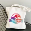 White canvas tote bag with teacher dinosaur print, casual shoulder shopping bag for daily use. - Style 17 (Dinosaur Teaching) / 35x40cm