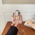 Charming pink mini handbag with gold chain strap and lock detail, stylish accessory for women. - Pink