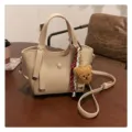 Beige leather tote bag for women, stylish crossbody shoulder bag with cute bear charm. - With Pendant / Off White