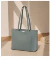 Close-up view of the grey-green leather tote bag showing double straps and metallic bar detail. - 35*14*27 / Blue (Artificial Pearl Decoration)