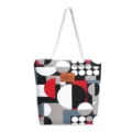 Close-up detail of canvas tote bag with geometric pattern print and white rope handle. - Circle