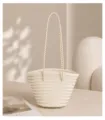 Detailed shot of a French vintage woven bucket bag, elegant handmade leather handbag design. - Cream