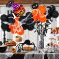 Halloween balloon arch kit with black orange balloons and pumpkin foil decorations. - Halloween Black and Orange Balloon Chain 2
