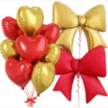 Detailed view of red and gold foil heart and bow balloons set for party decoration. - Red Gold Heart Bow Combination