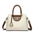 Elegant two-tone women handbag with braided handle and shoulder strap, front view studio shot. - Off White