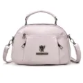 Stylish pink women shoulder crossbody bag with top handle and metal monkey logo design. - 24*12*15 / Pink