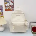 Zaino scolastico per studenti minimalista in tinta unita con simpatico ciondolo in peluche. - Bianco
